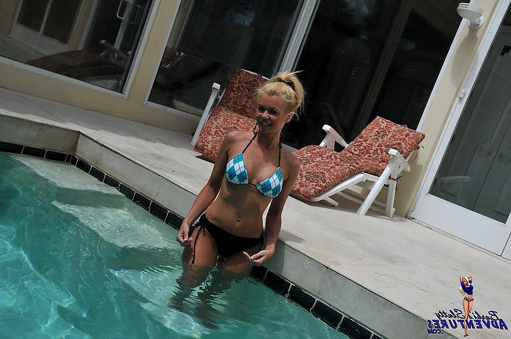 15P Cute blonde MILF Barbi Sinclair shows her fantastic body wearing sexy bikini in the pool.