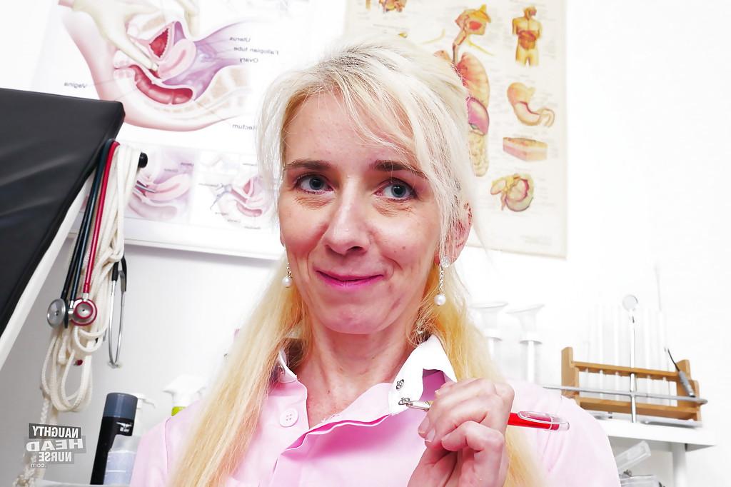 16P Older blonde nurse rids uniform before toying hairy cunt with large sex toy