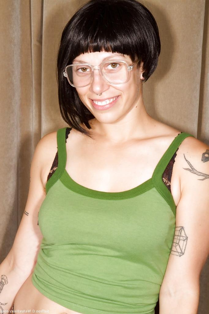 16P Tattooed babe in glasses exposing her big boobs and hairy cunt