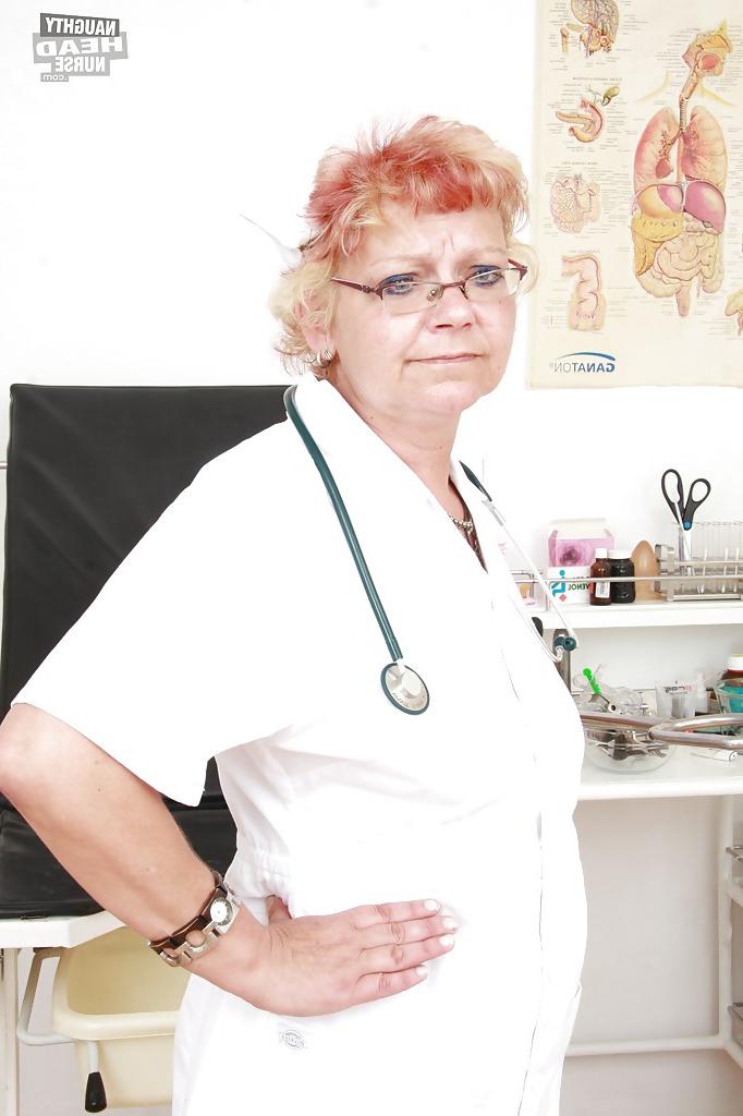 16P Filthy granny in nurse uniform stretching her twat by her fingers