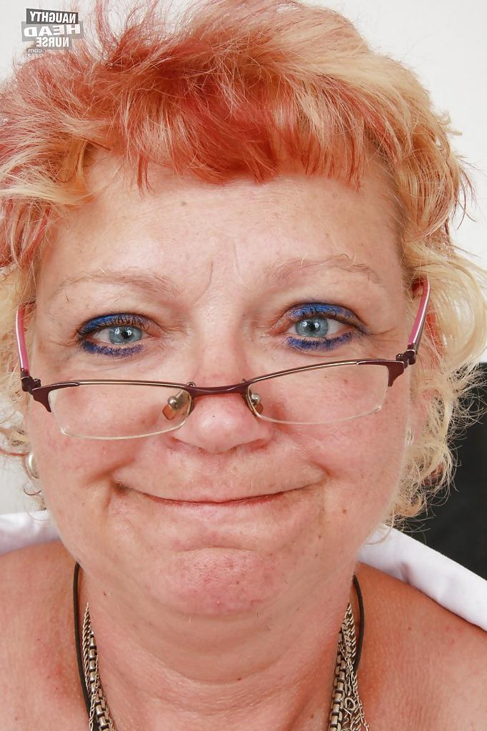 16P Filthy granny in nurse uniform stretching her twat by her fingers