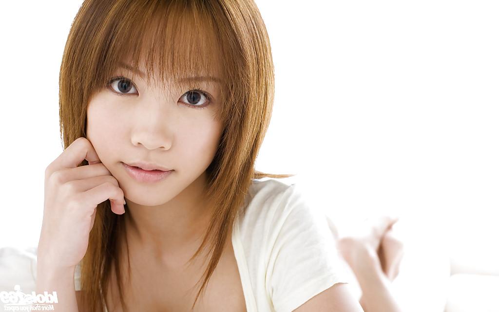 15P Asian teen cutie Reika Shina uncovering her titties and bushy cunt