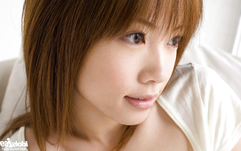 15P Asian teen cutie Reika Shina uncovering her titties and bushy cunt