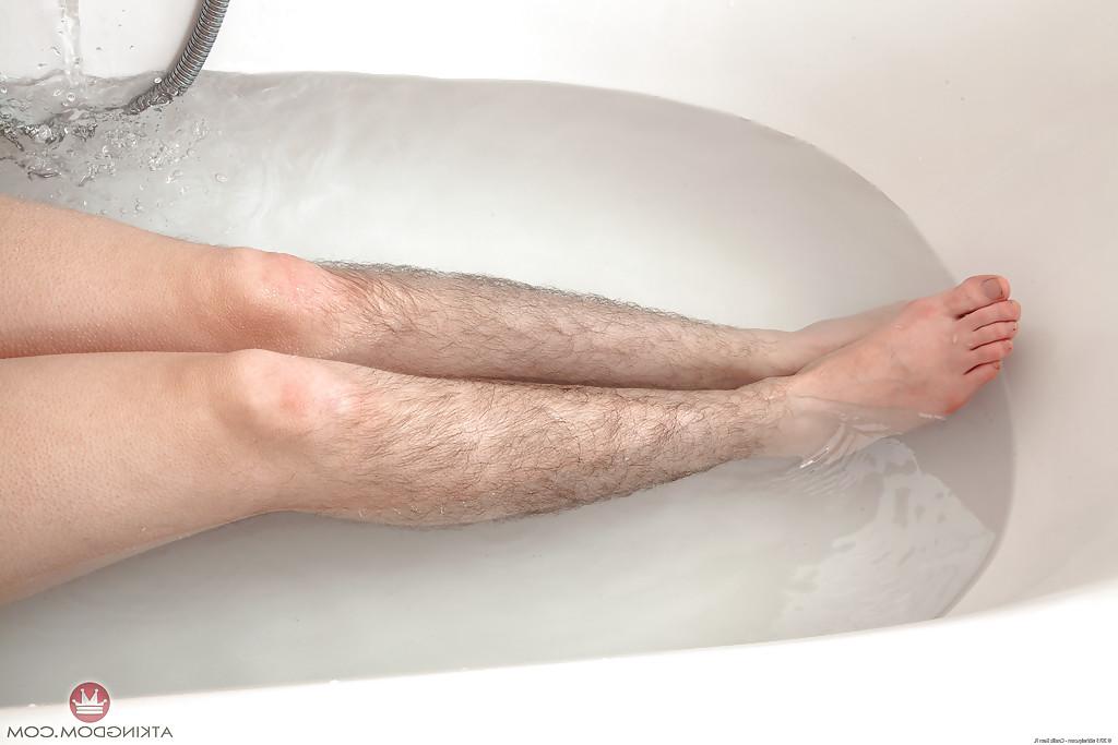 16P Hirsute mature broad displaying hairy legs and tiny tits in bathtub