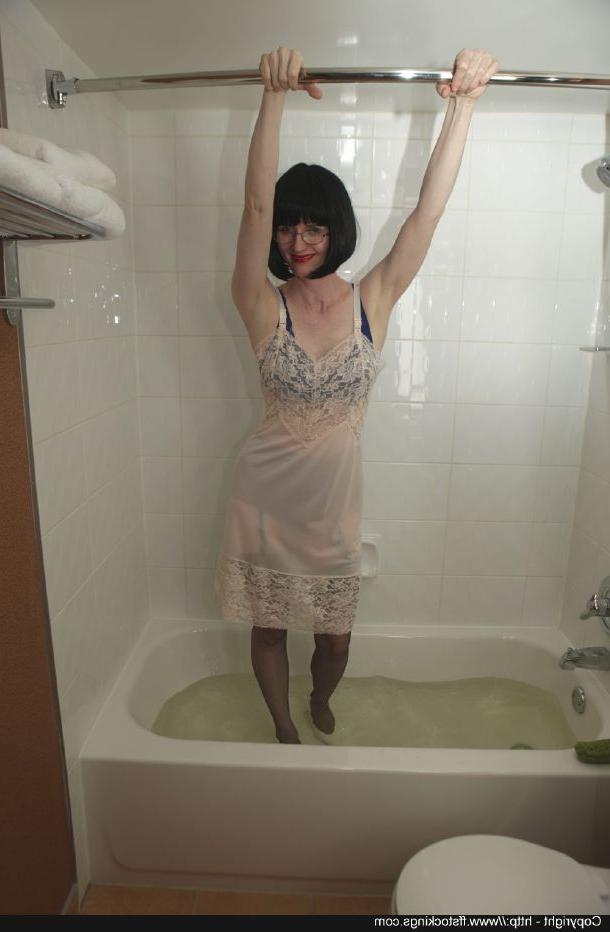 12P Dressed mature lady in black nylon stockings taking a bath