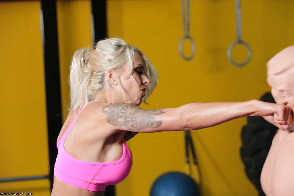 16P Tattooed blonde milf Nina Elle practices sports with oiled big tits