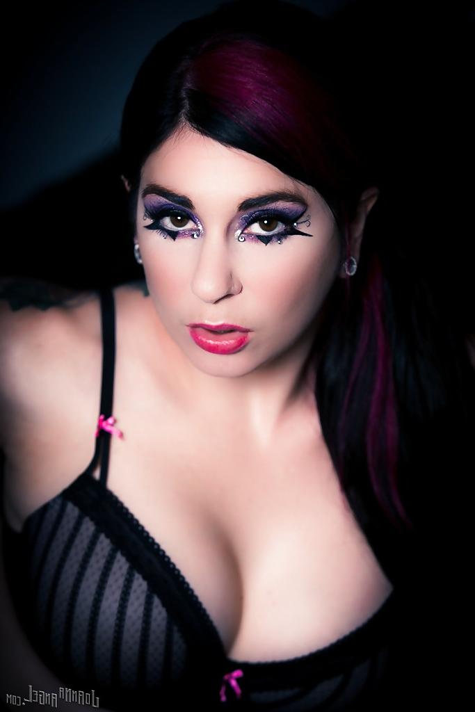 14P Ravishing punk princess in pantyhose and bra revealing her ample tits