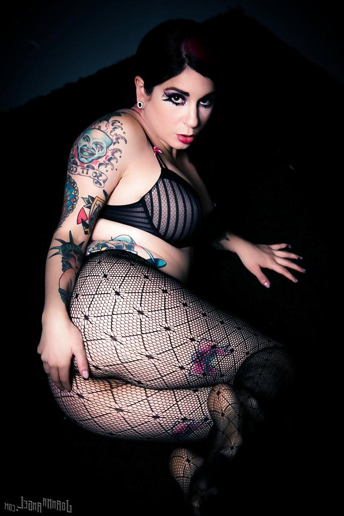 14P Ravishing punk princess in pantyhose and bra revealing her ample tits