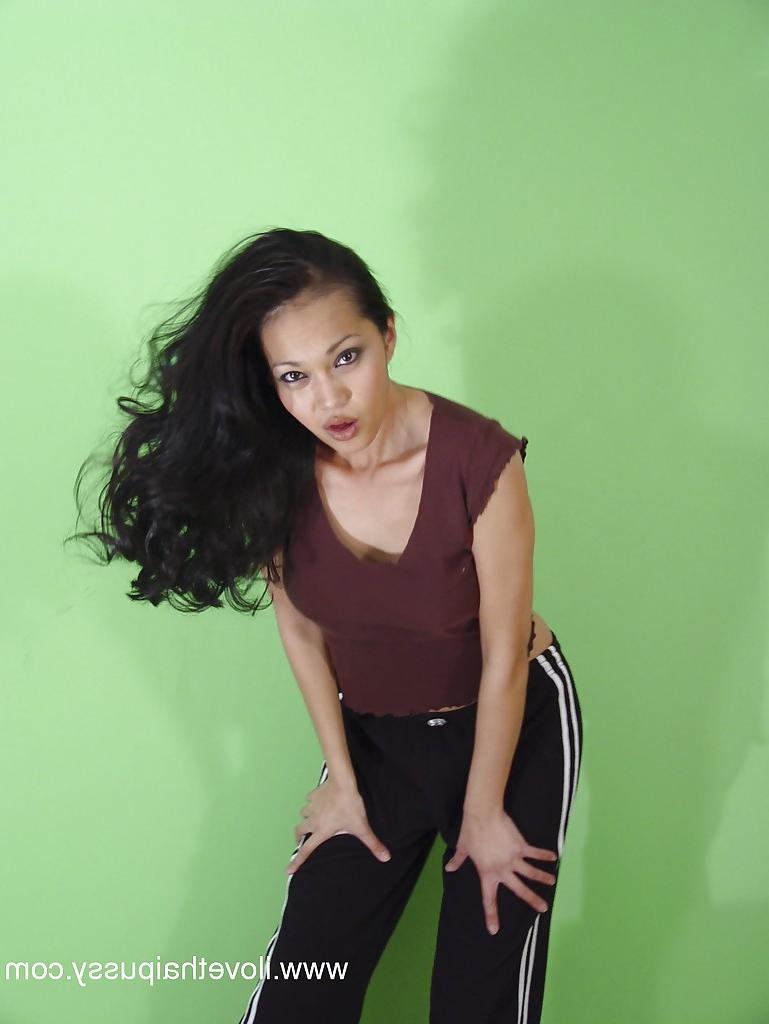 16P Playful thai seductress with hot curves getting rid of her clothes