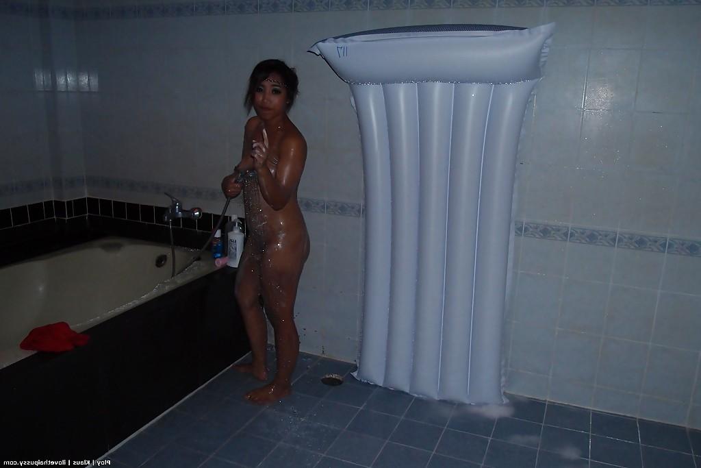 16P Seductive asian babe taking off her clothes and taking bath