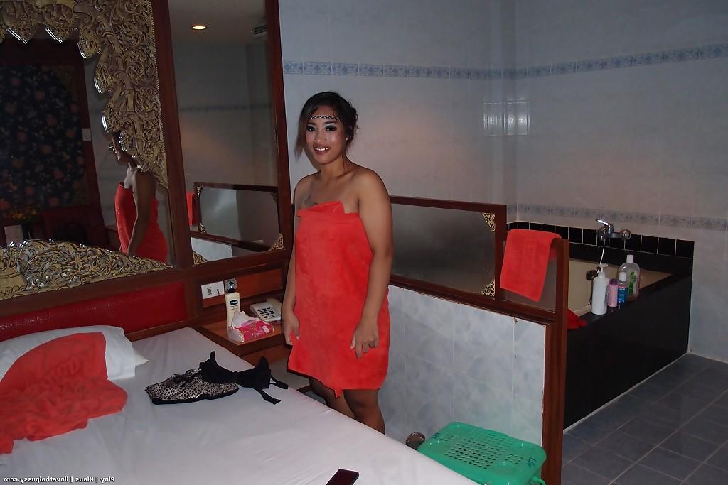 16P Seductive asian babe taking off her clothes and taking bath