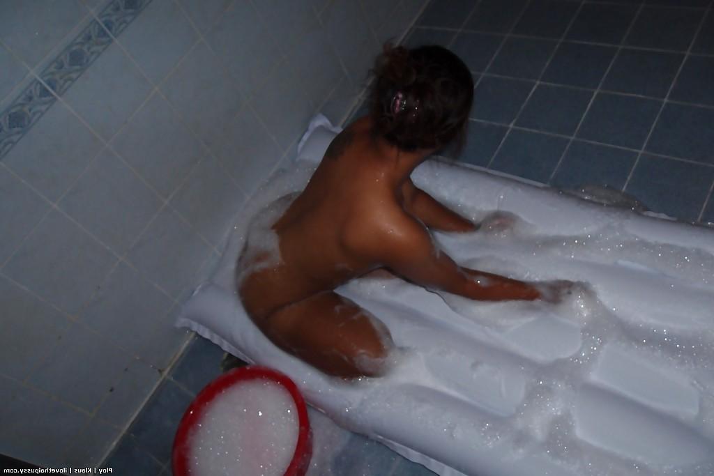 16P Seductive asian babe taking off her clothes and taking bath