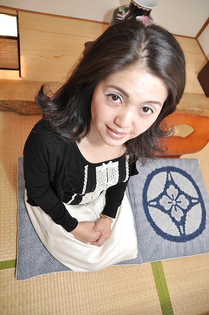 16P Miyoko Tanigawa is featured in a hot undressing scene in her living room
