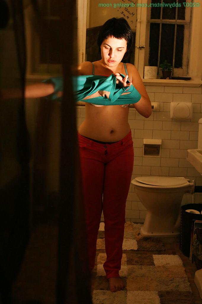 16P Hidden camera films short haired girl getting dressed after taking bath
