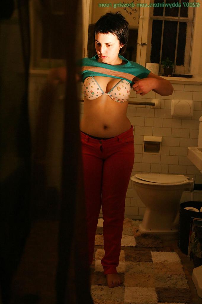 16P Hidden camera films short haired girl getting dressed after taking bath
