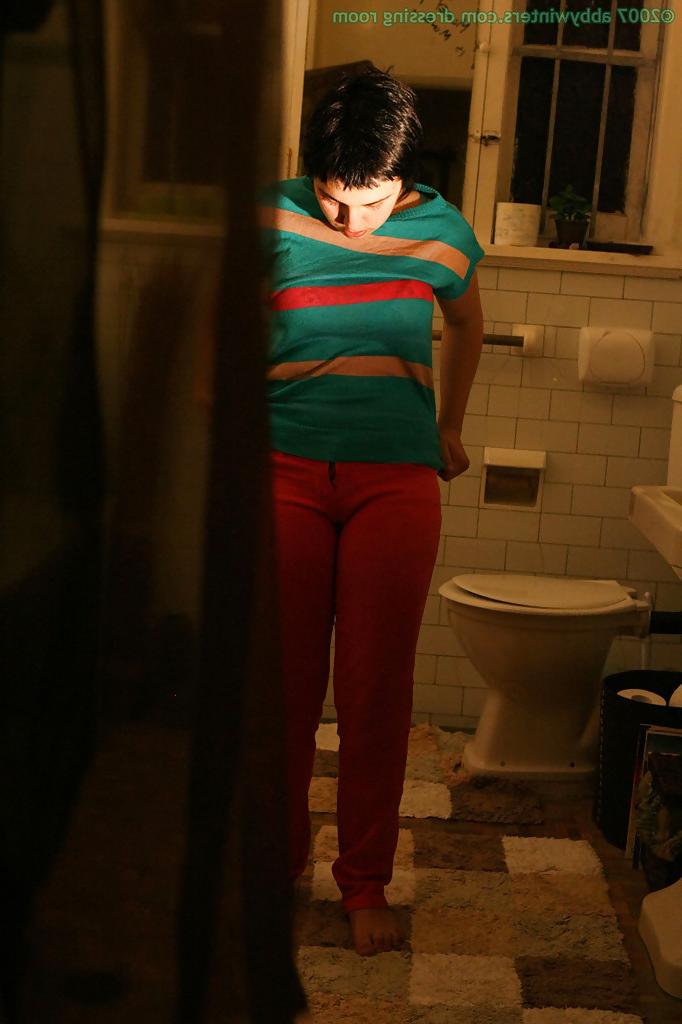 16P Hidden camera films short haired girl getting dressed after taking bath