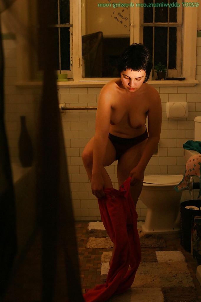 16P Hidden camera films short haired girl getting dressed after taking bath