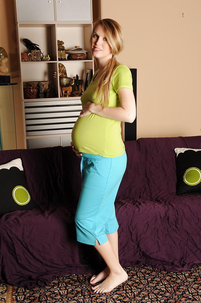 15P Smiley pregnant amateur with puffy nipples and hairy gash getting naked