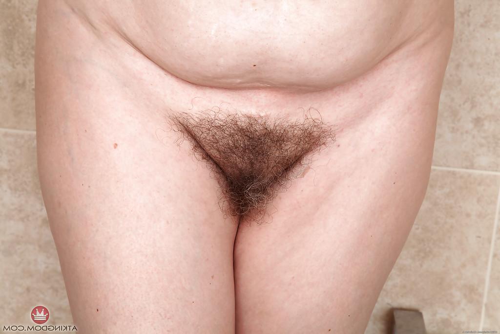 16P Older lady Christina X baring flabby stomach and hairy pussy
