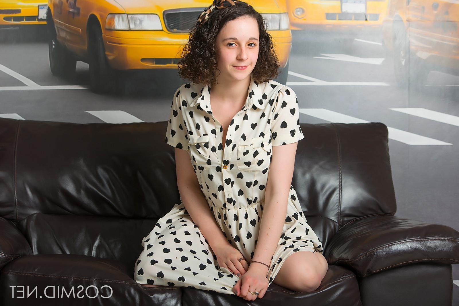 16P Cute busty coed Hanna Bollie strips out of her dress on the leather couch