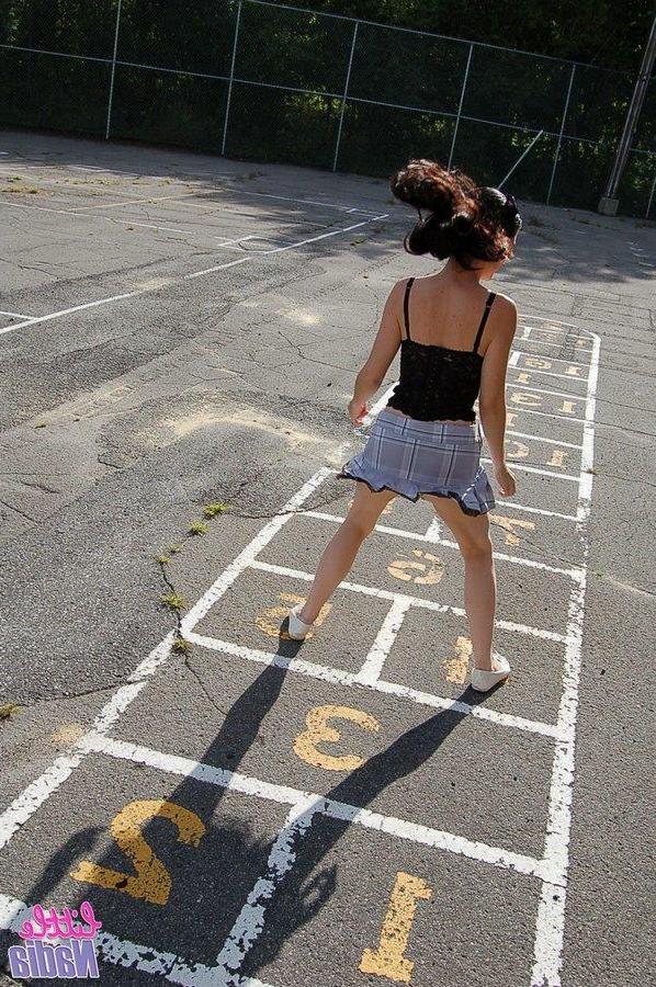 15P Pictures of teen girl Little Nadia showing off her hot ass outside