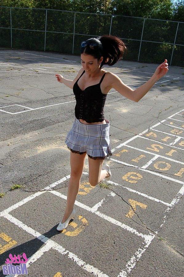 15P Pictures of teen girl Little Nadia showing off her hot ass outside
