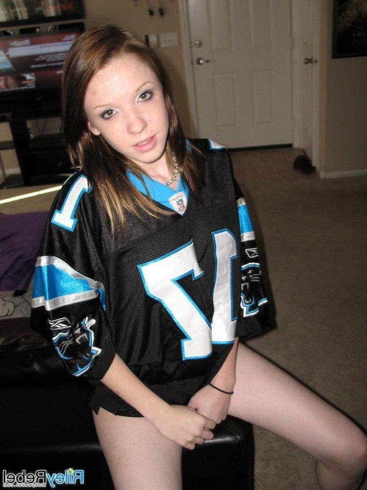 20P Pictures of teen Riley Rebel stripping totally nude in the living room