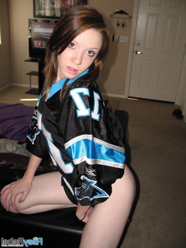 20P Pictures of teen Riley Rebel stripping totally nude in the living room