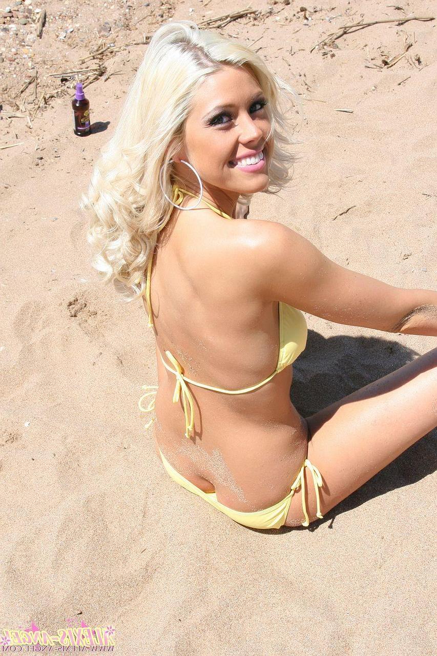16P Pictures of teen star Alexis Angel catching some rays on a beach