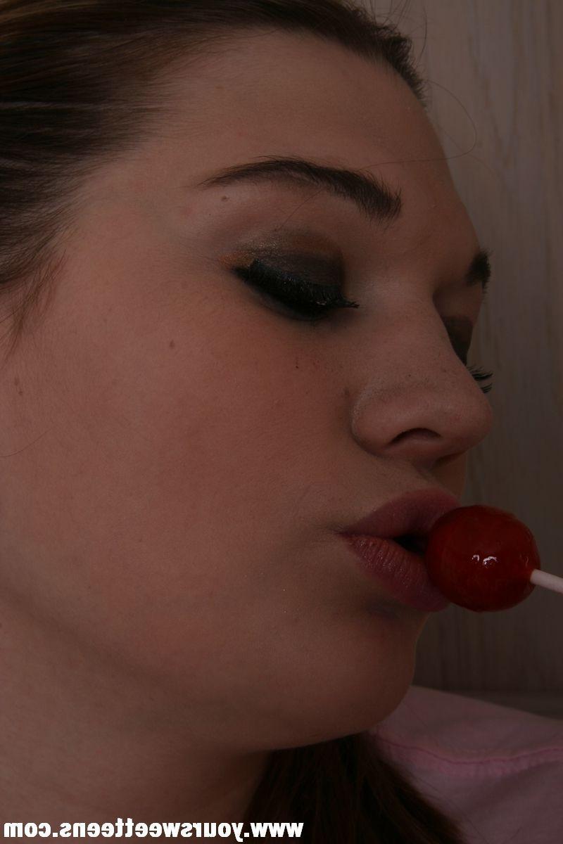 15P Pictures of a teen girl in panties and pigtails sucking on a lolipop