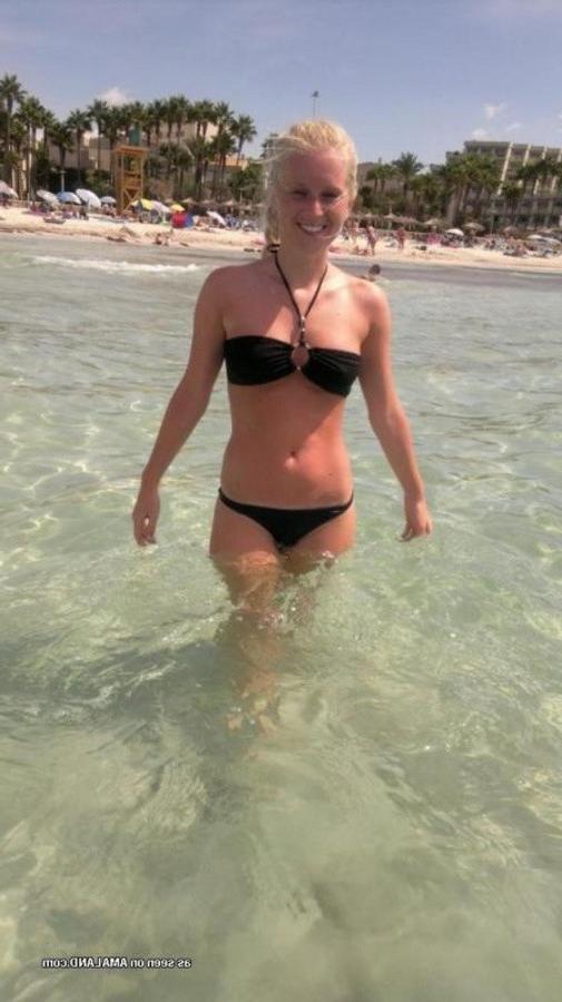 12P Photos of a sexy blonde babe posing in her black bikini