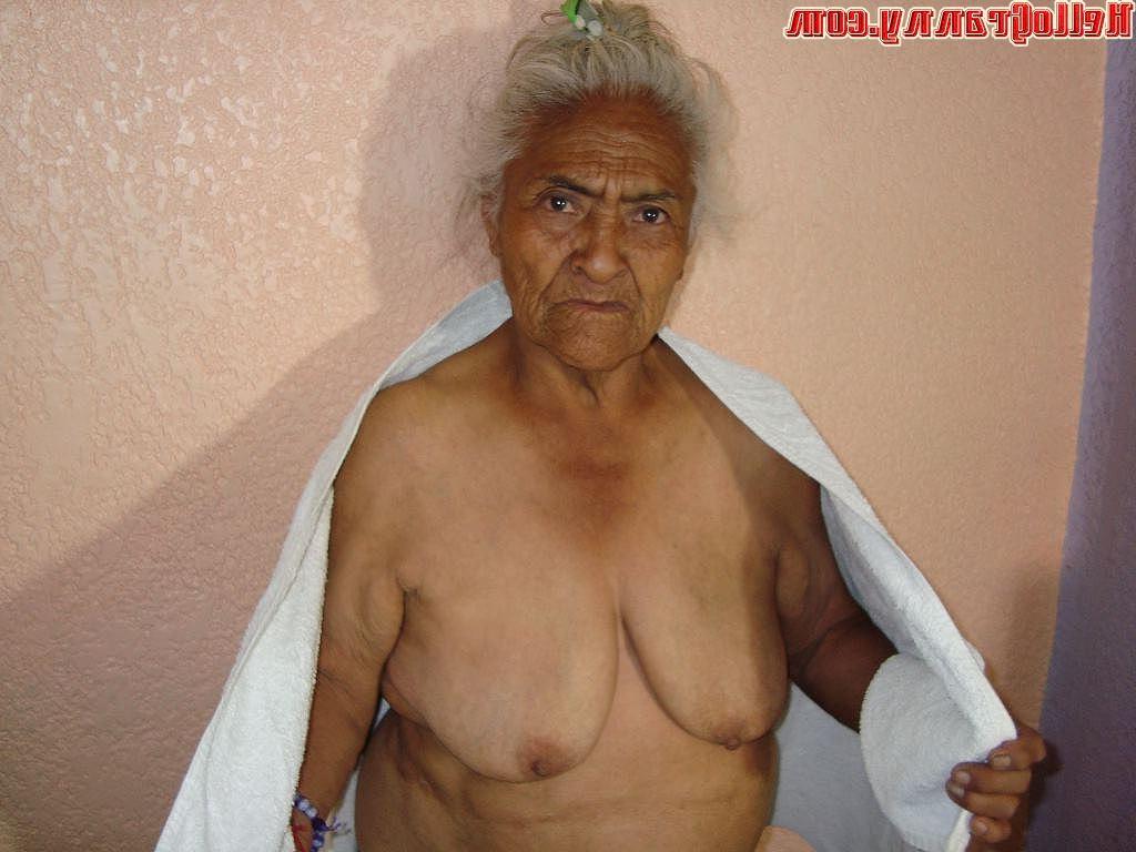 16P Granny in chair shows her pussy and big tits
