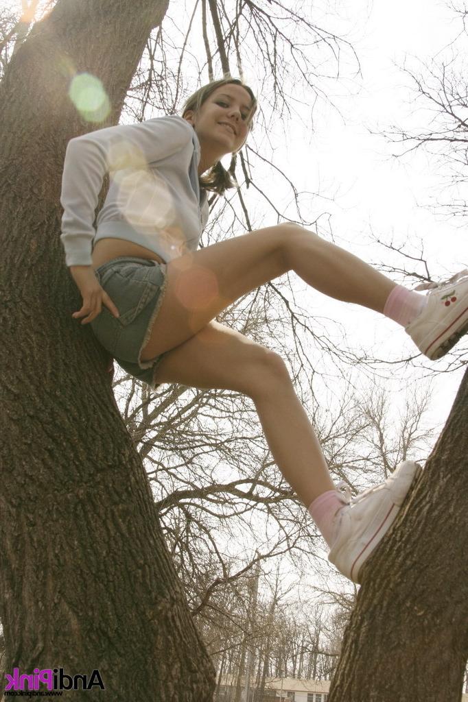 16P Cute teen girl climbing tree outdoors