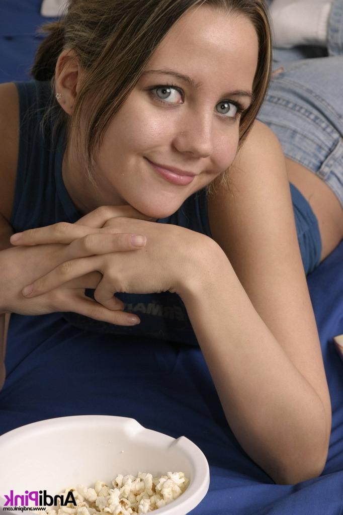 16P Cute teen girl eats popcorn