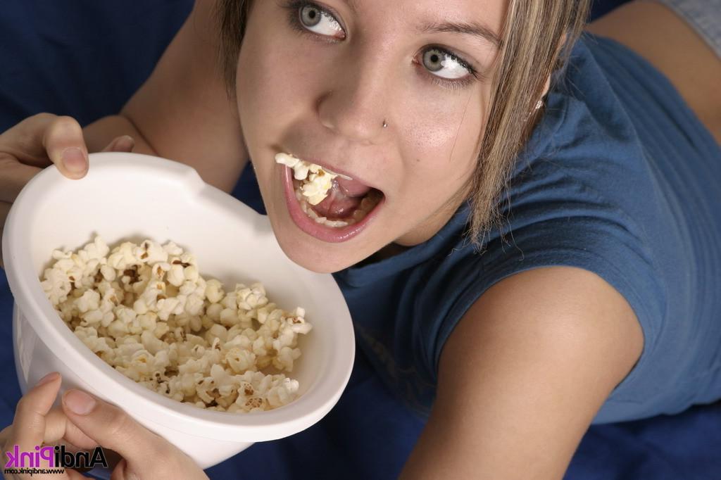 16P Cute teen girl eats popcorn