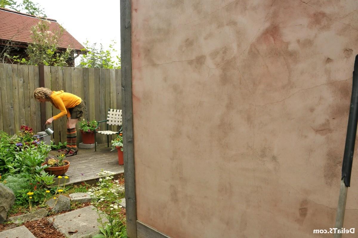 15P Upskirts of hung shemale Delia outside watering plants