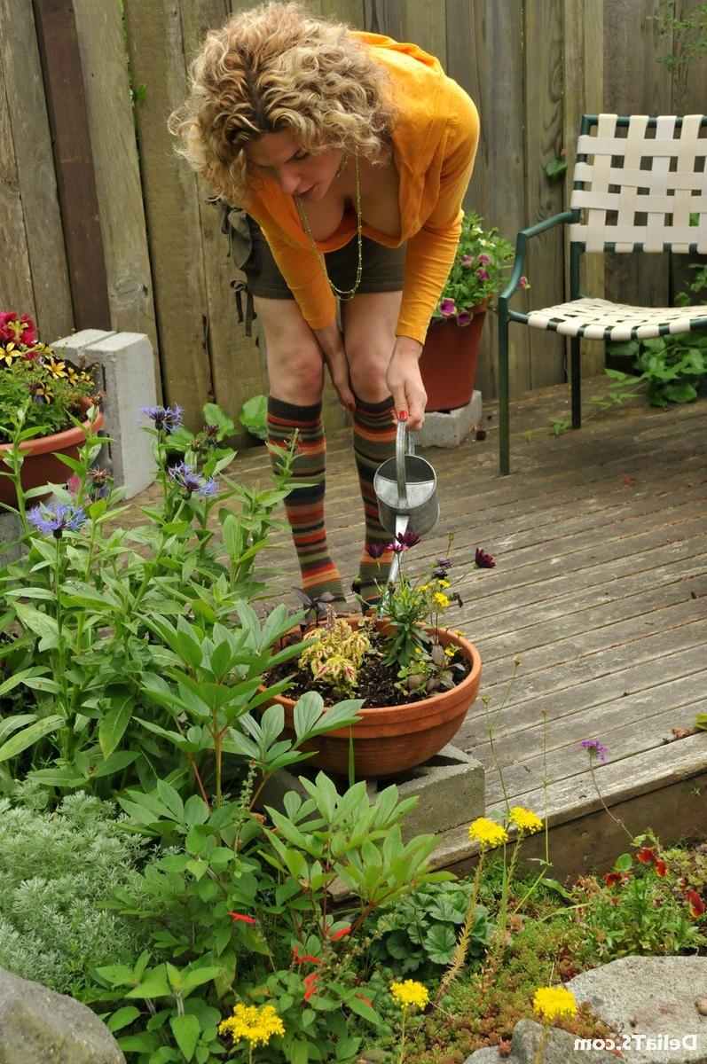 15P Upskirts of hung shemale Delia outside watering plants