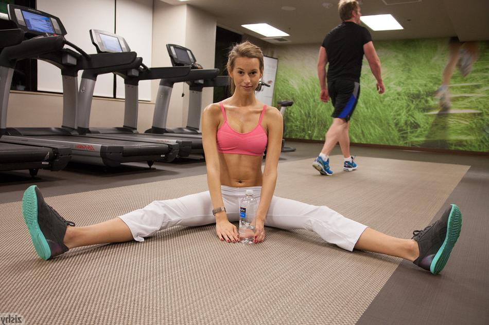 20P Lithe teen girl in white yoga pants and pink sports bra stretching and exercisin