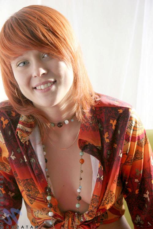 10P Cute redhead has her shirt open and no bra under there