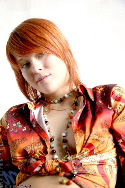 10P Cute redhead has her shirt open and no bra under there