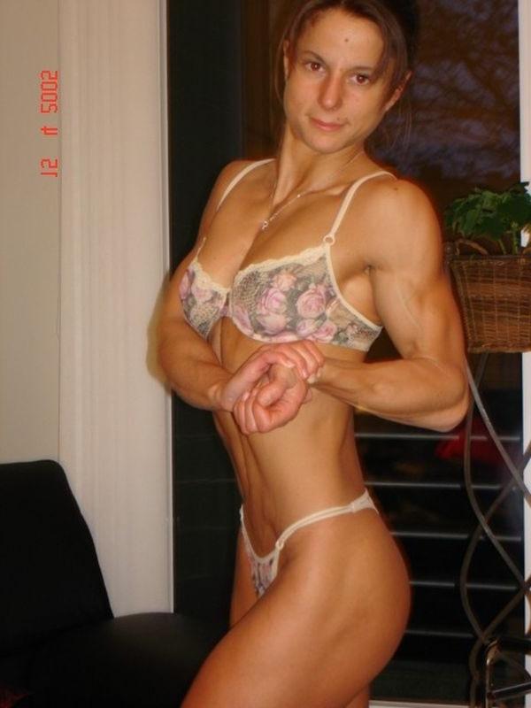 15P Pretty muscle teen teasing on her sofa in sexy flower bikini