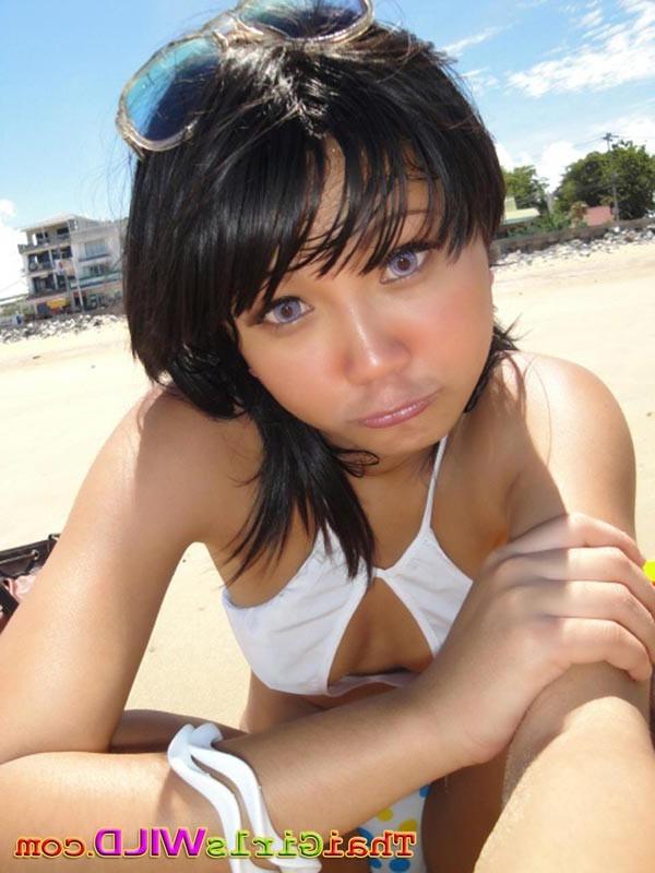 16P Cute little Thai amateur Febe poses at the beach and flashes