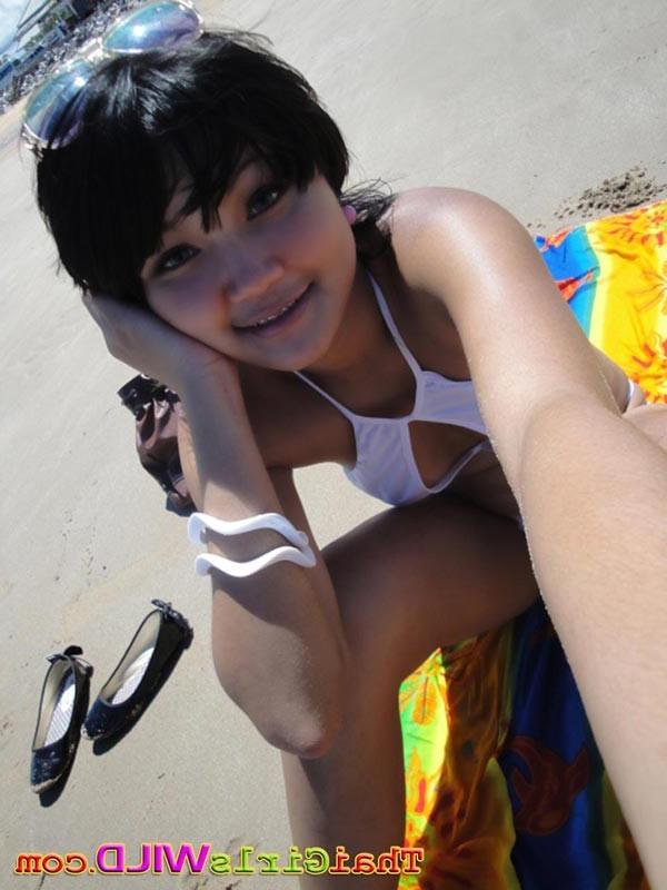 16P Cute little Thai amateur Febe poses at the beach and flashes