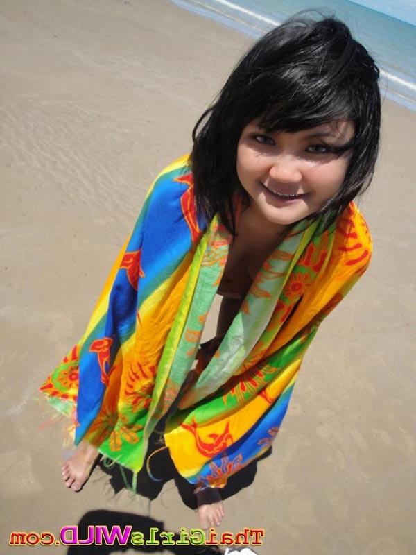 16P Cute little Thai amateur Febe poses at the beach and flashes