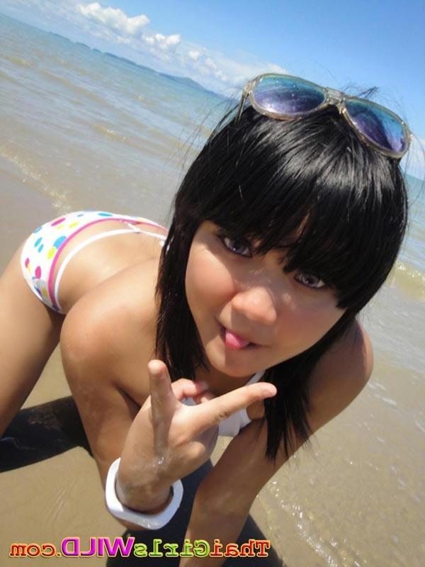 16P Cute little Thai amateur Febe poses at the beach and flashes