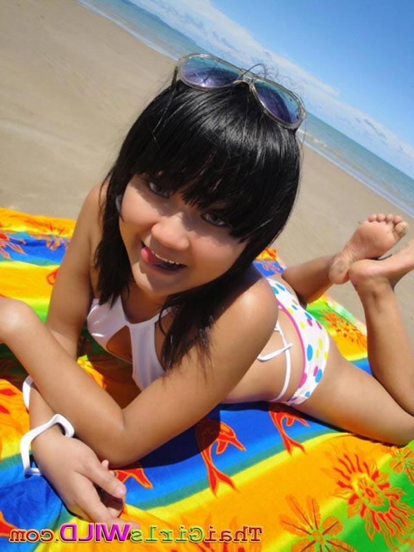 16P Cute little Thai amateur Febe poses at the beach and flashes
