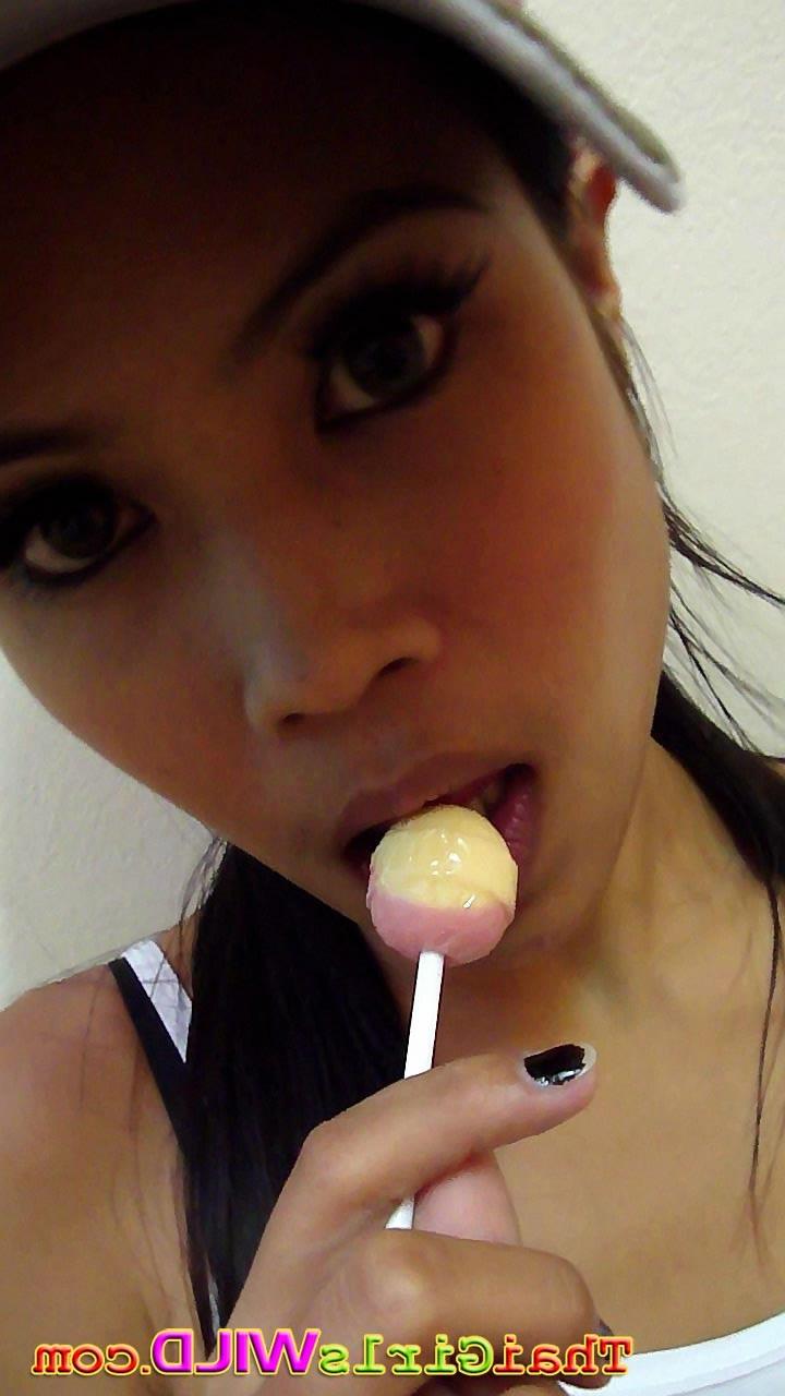16P Hot THai babe named Ni licks and sucks a lolipop to tease us