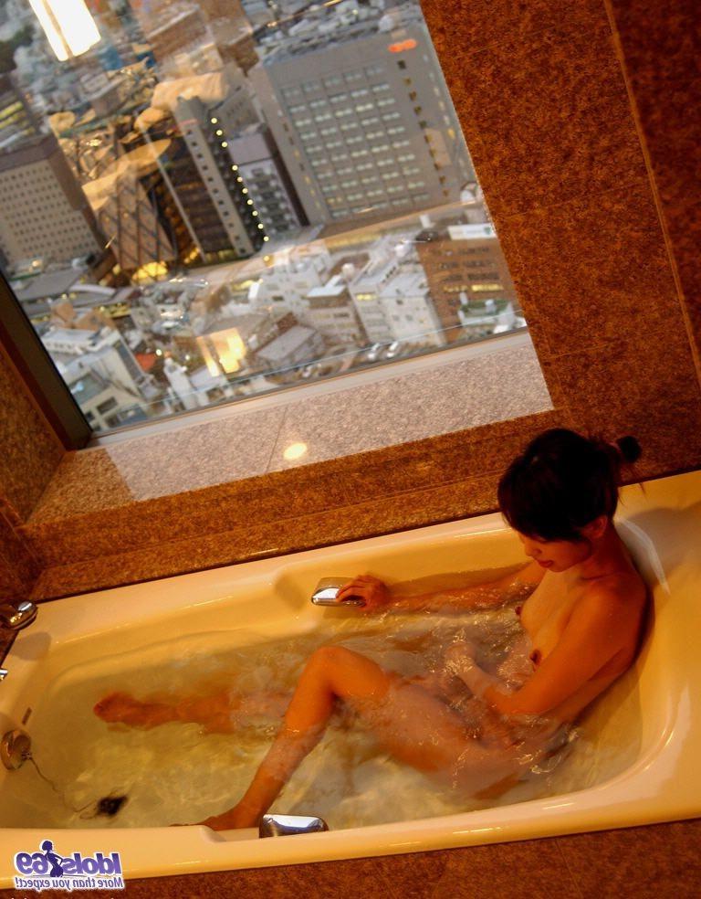 16P Hot Japanese tramp is naked on her bed showing off her body