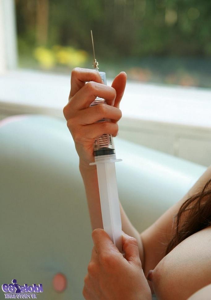 16P Beautiful Japanese nurse strips down and plays with an injection