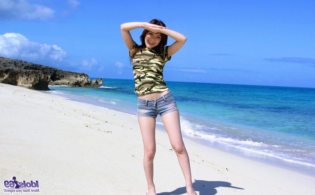 15P Petite Japanese girl with tiny shorts strips naked on the beach